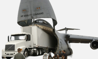 truck driving out of the back of an airplane