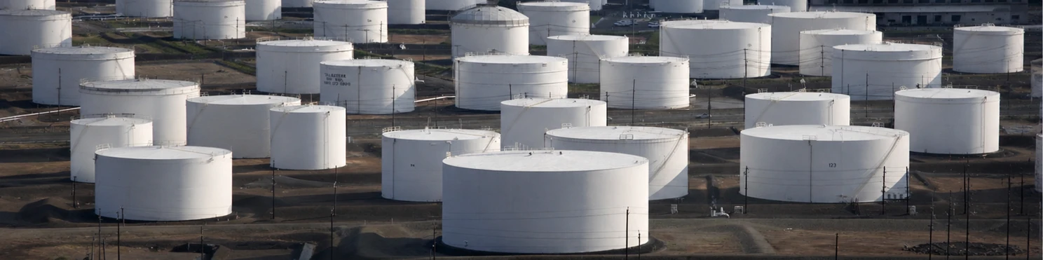 white oil storage tanks at an industrial facility
