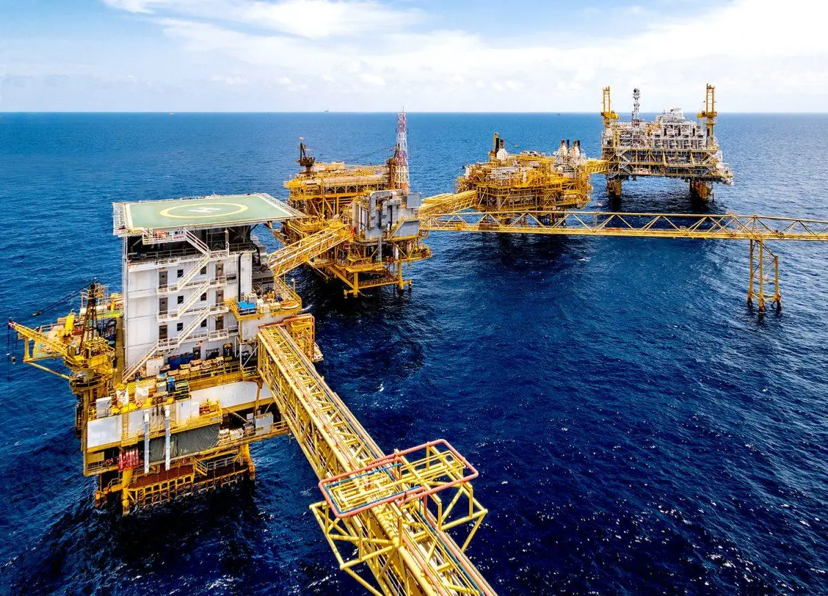 aerial view of fixed offshore oil and gas production platforms connected by bridges at sea