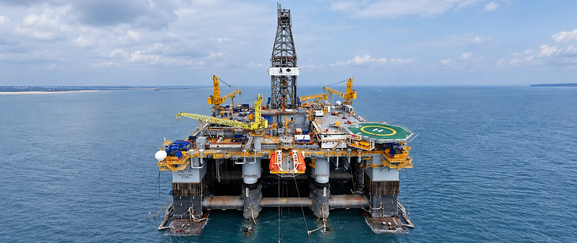 Offshore oil and gas drilling platform with deck equipment, cranes and drilling systems.