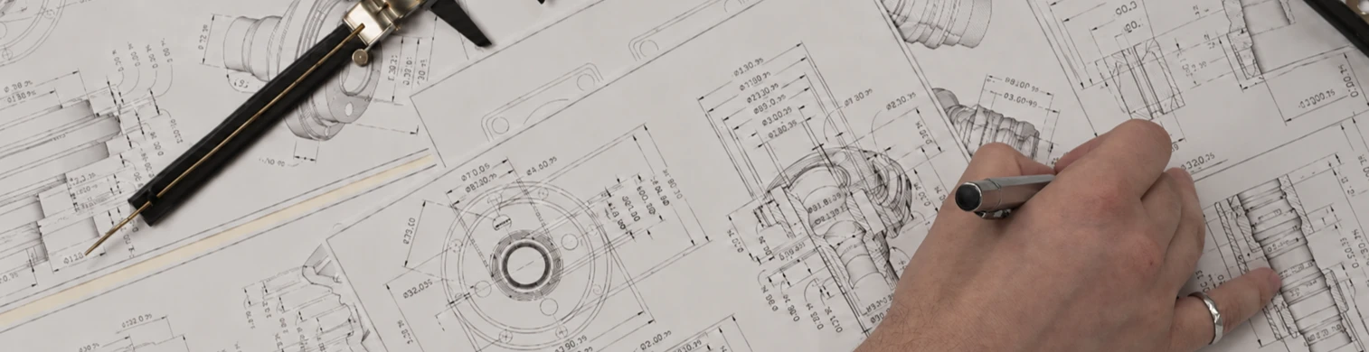 Engineering drawings and dimensional specifications reviewed with a precision caliper.