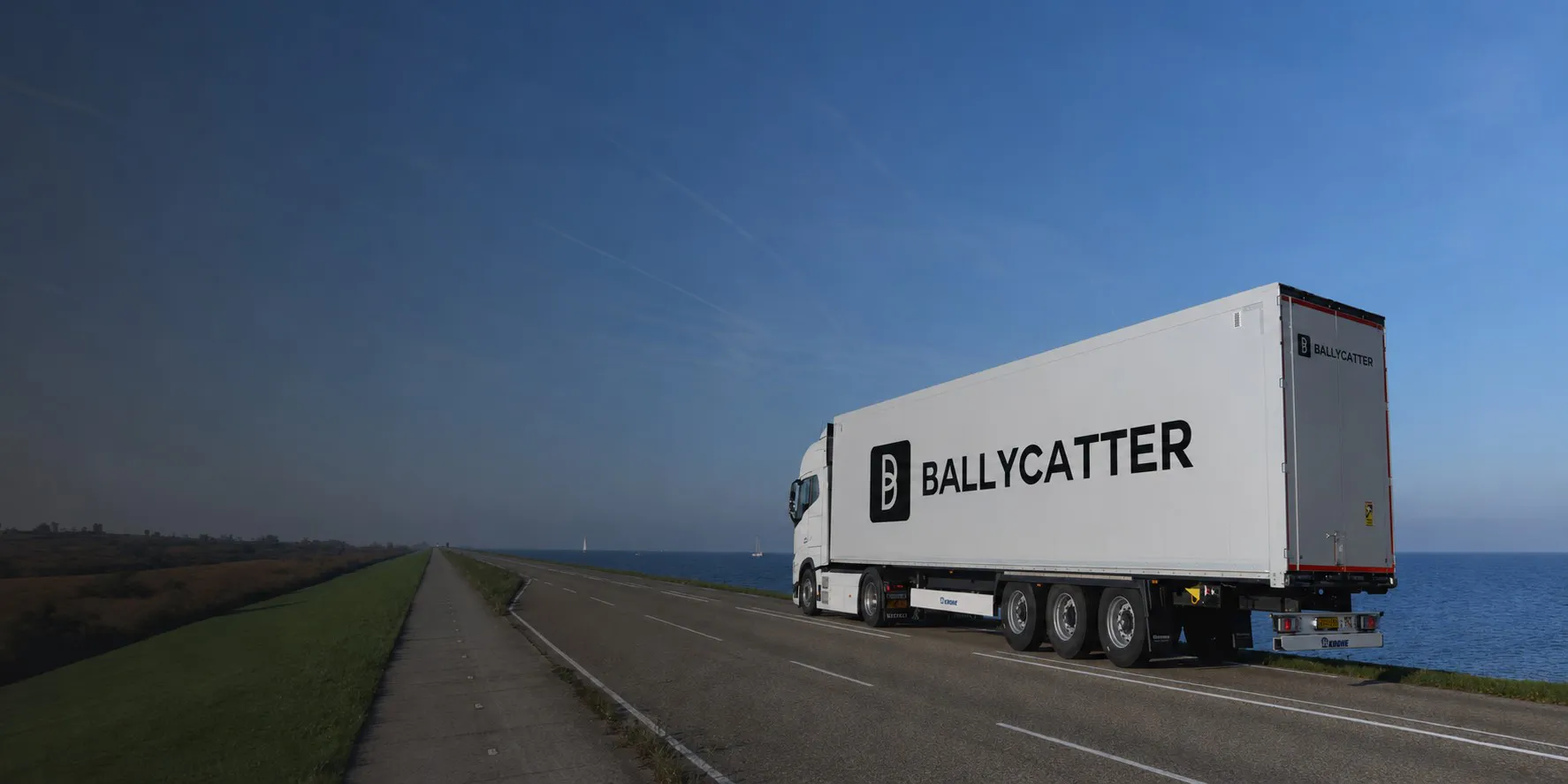 Ballycatter truck transporting project equipment along a coastal highway.
