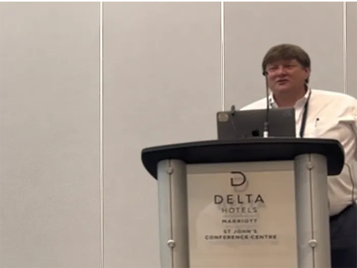 Rod Gibbons speaking at an oil and gas industry presentation